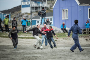 Tourists meet locals in a friendly game of soccer Photo: Mads Phil – Visit Greenland